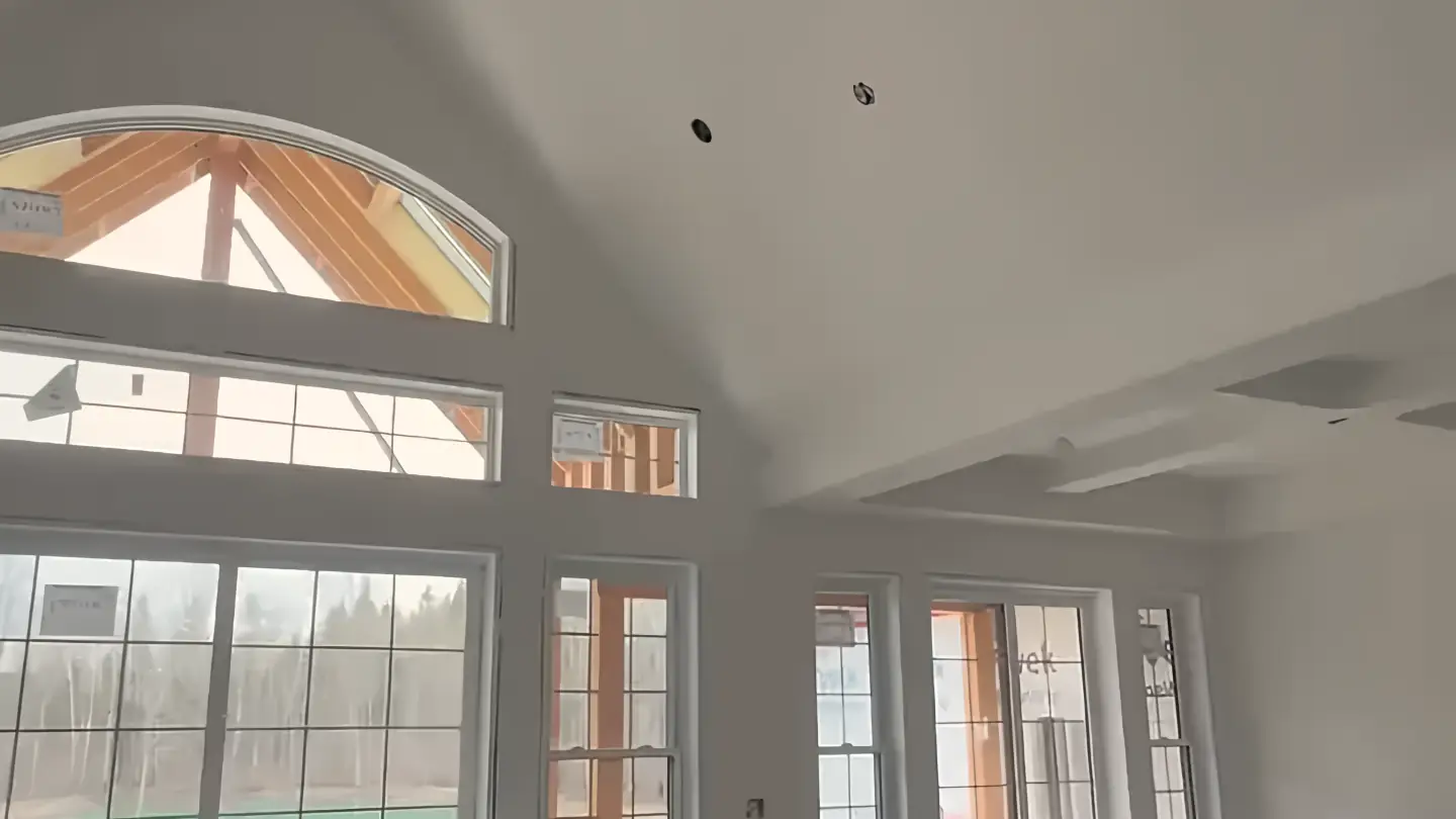 A KOSO job: a vaulted great room with a Level 5 finish on the walls and ceiling, under a wall of windows.